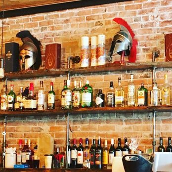 Yamas Greek Eatery - a brick wall with shelves of liquor - Greek Near Me - Walla Walla, Washington Yamas Greek Eatery - a brick wall with shelves of liquor - Greek Near Me - Walla Walla, Washington
