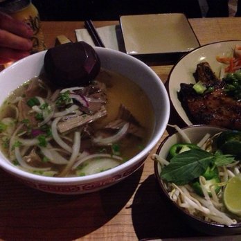 District Saigon - Wood and Herb Smoked Brisket Pho $13.00 Rice noodles served w/grandmother's secret beef broth garnished w/cilantro & red onions - Vietnamese Near Me - Astoria, New York