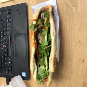 Banh Mi Cart - Grilled chicken bahn mi, spicy. Laptop in background for relative size comparison. - Vietnamese Near Me - New York, New York