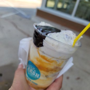 Andy's Frozen Custard - a hand holding a cup of ice cream - Desserts Near Me - Grapevine, Texas