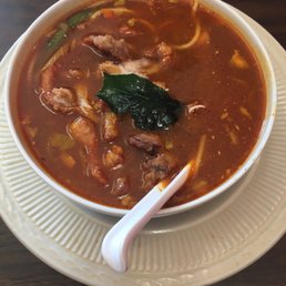 a bowl of soup on a plate a bowl of soup on a plate