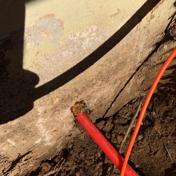 C Squared Designs - a red hose connected to a concrete wall - Door Sales/Installation Near Me C Squared Designs - a red hose connected to a concrete wall - Door Sales/Installation Near Me