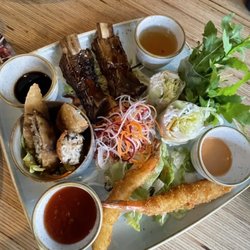 Cô Chu - Appetizer sample platter with summer rolls, crispy prawns, pork rib and spring roll with a side of Kim chi