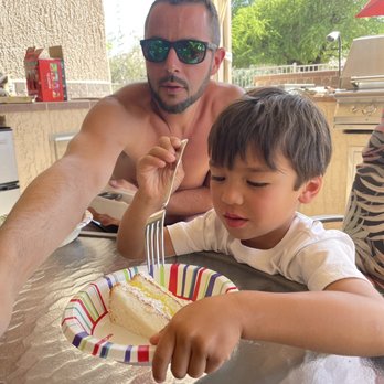 West Valley Tile Pros - a man and a young boy eating cake - Flooring Near Me - Surprise, Arizona