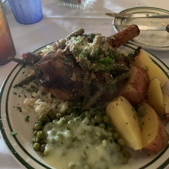 Olympia Cafe - Lamb Shank served on rice and green beans, side of sweet peas and lemon potatoes. Excellent portion, fork tender and Outstanding taste! - Greek Near Me - Savannah, Georgia Olympia Cafe - Lamb Shank served on rice and green beans, side of sweet peas and lemon potatoes. Excellent portion, fork tender and Outstanding taste! - Greek Near Me - Savannah, Georgia