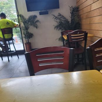 Thai Dish - a man sitting at a table in a restaurant - Thai Near Me - Boston, Massachusetts