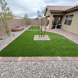 Toros Landscaping - New backyard remodel including artificial turf, rock, paver border and planting. Call today for your estimate!