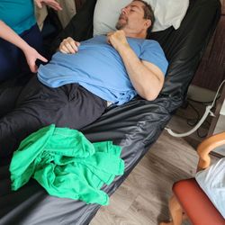 No sheets on bed. He chokes due to throat cancer and was left laying flat