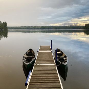 Wolf Cove Inn - Sunrise on the pond.  Two canoes that you can take out.  They also had a couple individual and one tandem kayak. - Hotels Near Me - Poland, Maine