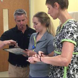 Emergency Medical Education - CEO Mark training on the CPR Command System board