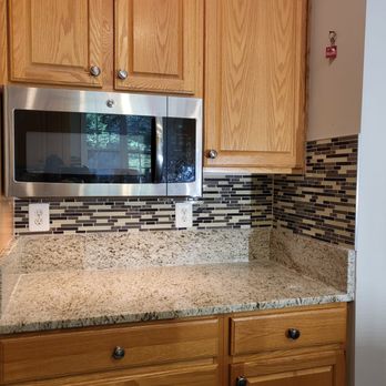 Quality Solutions - a kitchen with a stainless steel microwave - Flooring Near Me Quality Solutions - a kitchen with a stainless steel microwave - Flooring Near Me