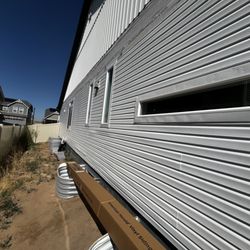 The Handy Huckaby - Vinyl siding repair in progress.