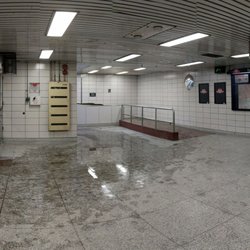 High Park Subway Station - Ramp for those with disabilities which leads to escalator up to bus bays. Collector booth visible as well. February 2018