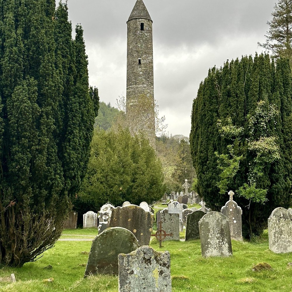 Wild Rover Tours - Glendalough Monastic Site (Round Tower in the background) - Tours Near Me - Dublin, D Wild Rover Tours - Glendalough Monastic Site (Round Tower in the background) - Tours Near Me - Dublin, D