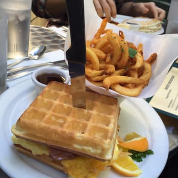 Snug Harbor - The wafflewhich was INCREDIBLE. Perfectly cooked scrambled eggs and Canadian bacon in between two golden waffles. - Diners Near Me - Santa Monica, California