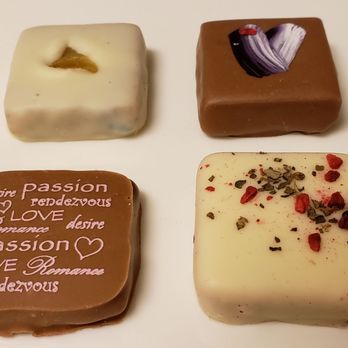 DeBrand Fine Chocolates - Clockwise from top left: Valencia, Jasmine, Raspberry Balsamic, Passion - Chocolatiers & Shops Near Me - Indianapolis, Indiana DeBrand Fine Chocolates - Clockwise from top left: Valencia, Jasmine, Raspberry Balsamic, Passion - Chocolatiers & Shops Near Me - Indianapolis, Indiana