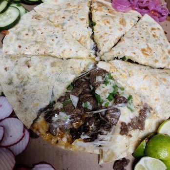 Tacos Ojo De Agua - a cut in half pizza - Food Trucks Near Me - Oxnard, California