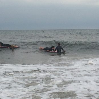 Wave Riding School - Floating on the board with an instructor, waiting for a good wave. - Surfing Near Me - Ocean City, Maryland Wave Riding School - Floating on the board with an instructor, waiting for a good wave. - Surfing Near Me - Ocean City, Maryland