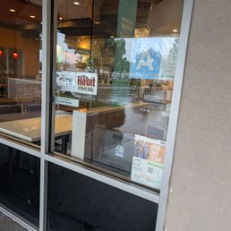 Exterior outside entrance of Habit Burger & Grill - Signs posted on the window - Norwalk, California Exterior outside entrance of Habit Burger & Grill - Signs posted on the window - Norwalk, California