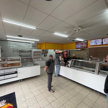Chick N Stop - a man and a woman standing in front of a counter - Salad Near Me - Cumberland, Maryland Chick N Stop - a man and a woman standing in front of a counter - Salad Near Me - Cumberland, Maryland
