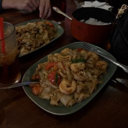 Two drunken noodles, one with beef and the other with shrimp, also two Thai tea's. Two drunken noodles, one with beef and the other with shrimp, also two Thai tea's.