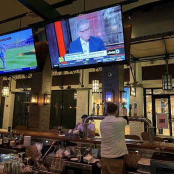 Barrio - a man watching television in a bar - Cocktail Bars Near Me - West Palm Beach, Florida Barrio - a man watching television in a bar - Cocktail Bars Near Me - West Palm Beach, Florida