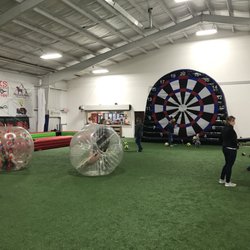Kickmaster Athletic And Event Center - Soccer billiards, hamster balls, and Velcro giant dartboard.