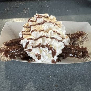 Churro - a desert with whipped cream and chocolate sauce - Desserts Near Me - Austin, Texas