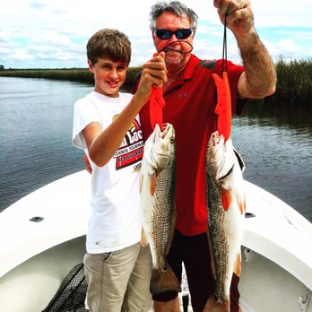 Tidelife Charters - Father and son on reds - Boat Charters Near Me - Eastpoint, Florida