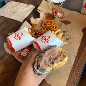 Arby's - a person eating a sandwich and fries - Fast Food Near Me - Deming, New Mexico