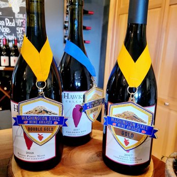 Hawkins Cellars - three bottles of wine on a wooden table - Wine Tasting Room Near Me - Underwood, Washington