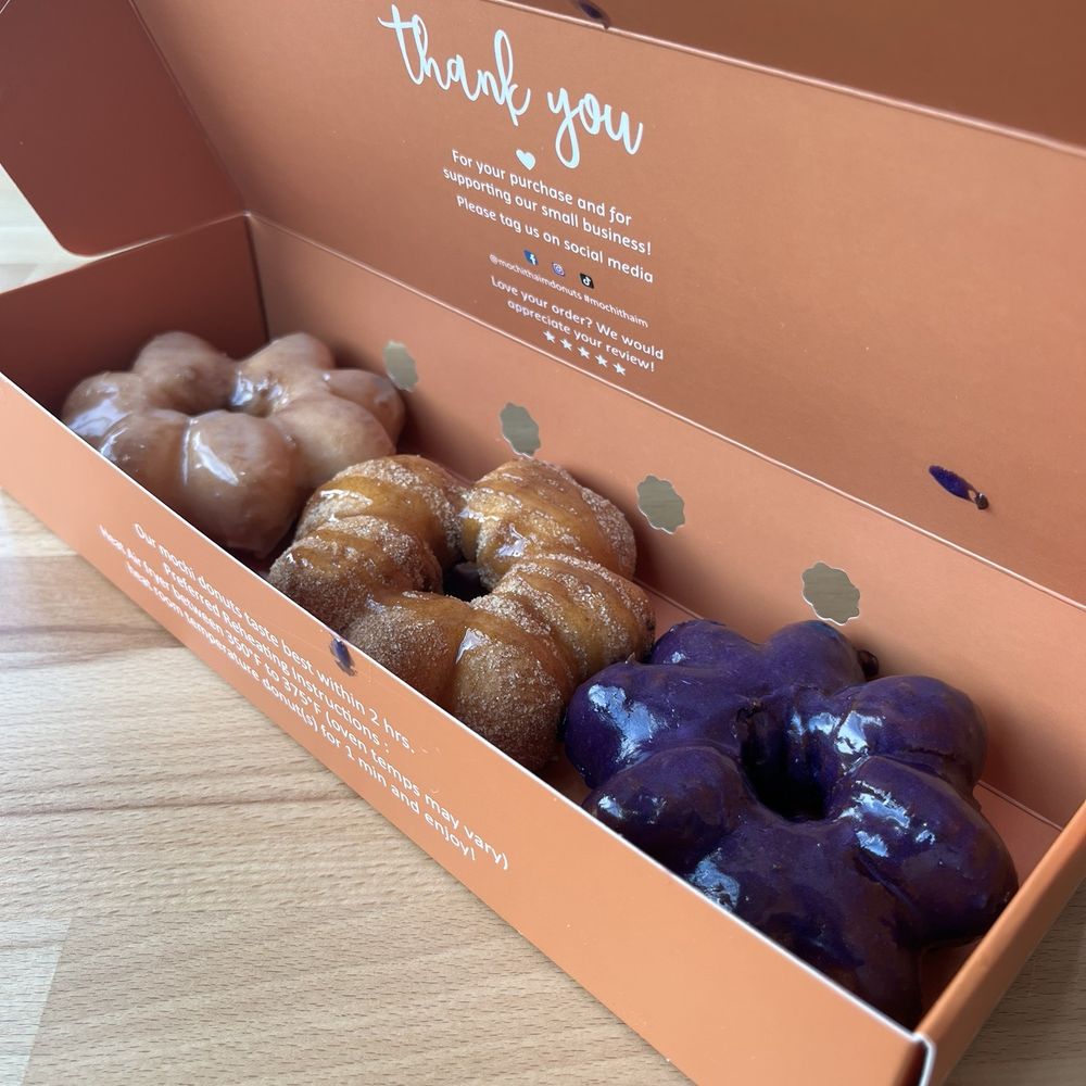 Mochi Thai'm Donuts - Right to Left: Ube, Caramel Drizzle Churro, and Classic Glaze - Bubble Tea Near Me - Colorado Springs, Colorado Mochi Thai'm Donuts - Right to Left: Ube, Caramel Drizzle Churro, and Classic Glaze - Bubble Tea Near Me - Colorado Springs, Colorado