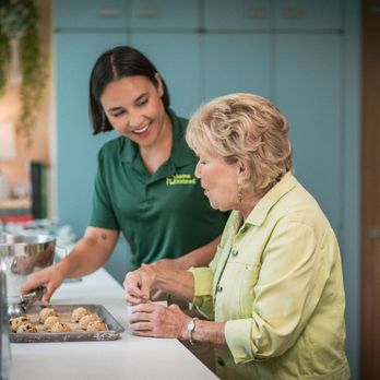 Home Instead - Care pro helping prepare a meal with a client - Home Health Care Near Me - Fort Myers, Florida Home Instead - Care pro helping prepare a meal with a client - Home Health Care Near Me - Fort Myers, Florida