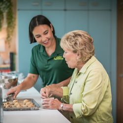 Home Instead - Care pro helping prepare a meal with a client