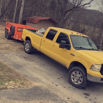 Reward Lawn Maintenance - a yellow truck and a red trailer - Landscaping Near Me Reward Lawn Maintenance - a yellow truck and a red trailer - Landscaping Near Me