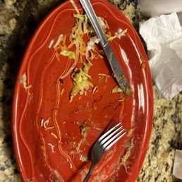 a red plate with a fork and knife a red plate with a fork and knife