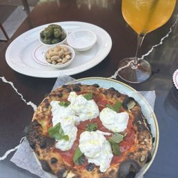 Burrata pizza, olives, passion fruit spritz Burrata pizza, olives, passion fruit spritz