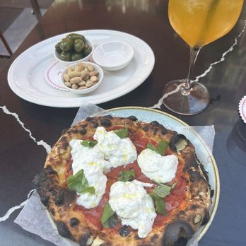Oretta - Burrata pizza, olives, passion fruit spritz - Italian Near Me - Toronto, Ontario Oretta - Burrata pizza, olives, passion fruit spritz - Italian Near Me - Toronto, Ontario