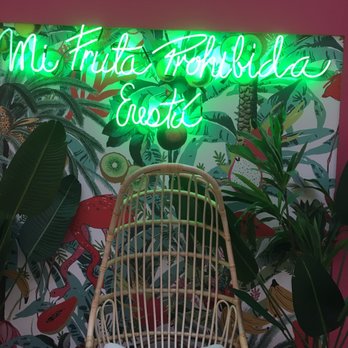 Amazonica - a chair in front of a neon sign - Shaved Ice Near Me - Miami, Florida