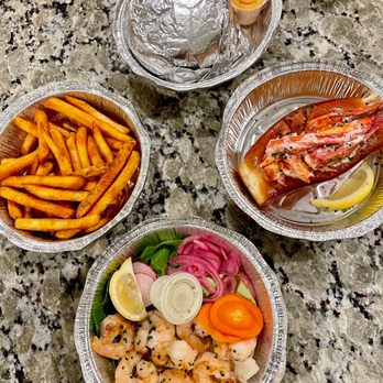Slapfish - Our spread: Traditional Lobster Roll, Natural Cut Fries, shrimp Lettuce Wrapped Shrimp & Surf N Turf Burger - Seafood Near Me - Indianapolis, Indiana