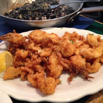 The Daily Catch - Calamari and squid ink aglio olio in the background - Italian Near Me - Boston, Massachusetts The Daily Catch - Calamari and squid ink aglio olio in the background - Italian Near Me - Boston, Massachusetts