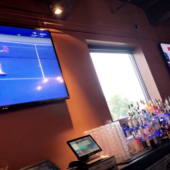 Cask'n Flagon - a man playing tennis on a large screen tv - Sports Bars Near Me - Boston, Massachusetts