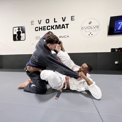 Evolve Checkmat Jiu Jitsu / Muay Thai Academy - Coach Hasaan Helping showing the technique of the night .