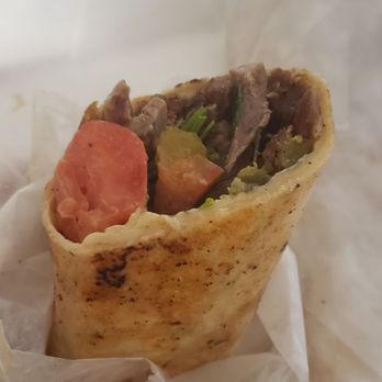 Anwar El Cajon market - Close up. Beef shawarma wrap with grilled tomato. - Halal Near Me - El Cajon, California Anwar El Cajon market - Close up. Beef shawarma wrap with grilled tomato. - Halal Near Me - El Cajon, California