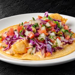 Fuego Cravings - Crispy fried fish topped with creamy chipotle sauce, fresh cabbage, and pico de gallo, all on two warm corn tortillas