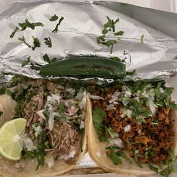 Carnitas taco and chorizo taco with a side order of jalapeño