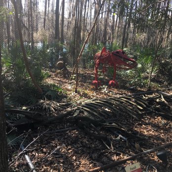 Tallahassee Museum - Allosaurus sculpted with car parts and a "fossil" below - Museums Near Me - Tallahassee, Florida