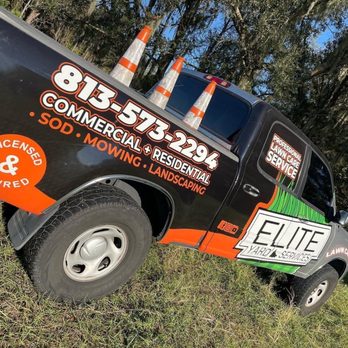 Elite Yard Services - a truck parked in a field - Lawn Services Near Me