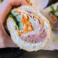 Lee's Bakery - Cross section of one banh mi dac biet. Two cost less than $12 after tax before tip on Sunday, August 11, 2024.