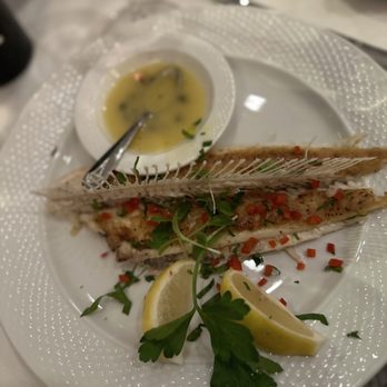 Il Monello - a plate of fish with lemon wedges - Italian Near Me - New York, New York Il Monello - a plate of fish with lemon wedges - Italian Near Me - New York, New York